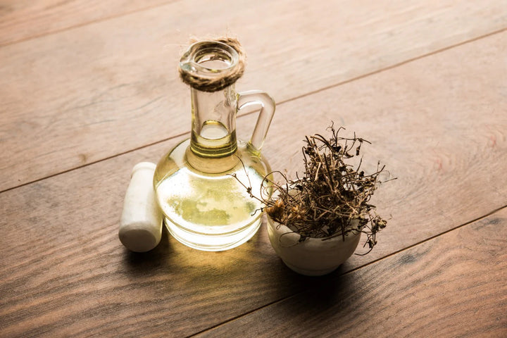 Oil Flask and planter kept on a table | Bhringraj oil for hair